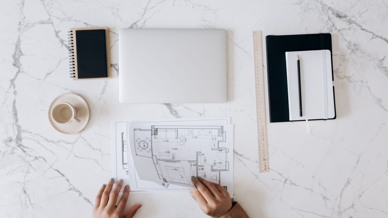 Architect reviewing plans at a desk