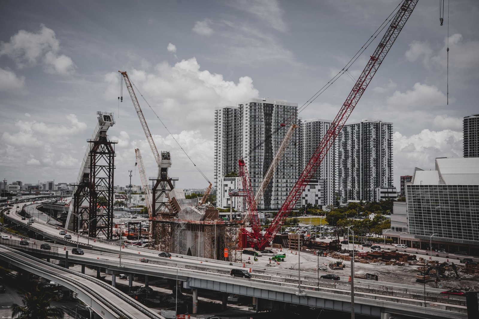 Flyover and high-rise construction with tower cranes